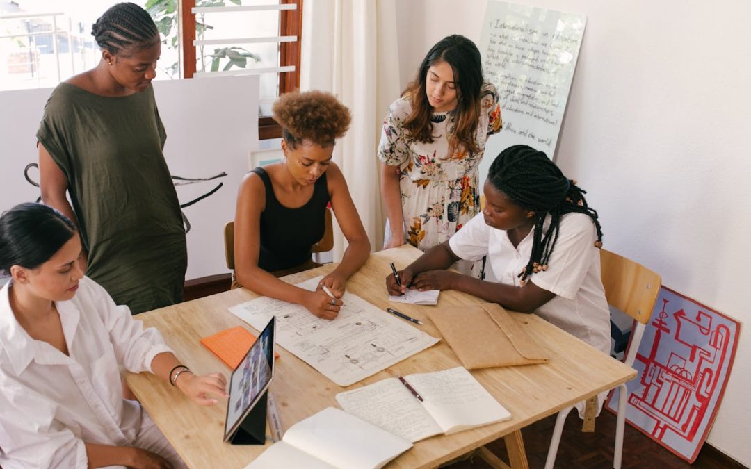 Entrepreneurs gathering at a table to discuss their plans